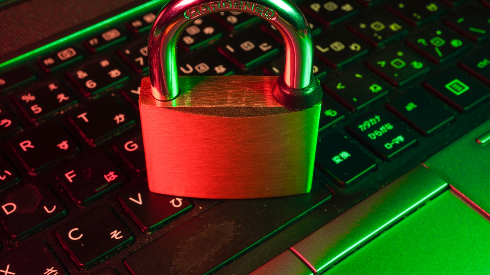 Red padlock on a computer keyboard representing digital identity security and onboarding risk